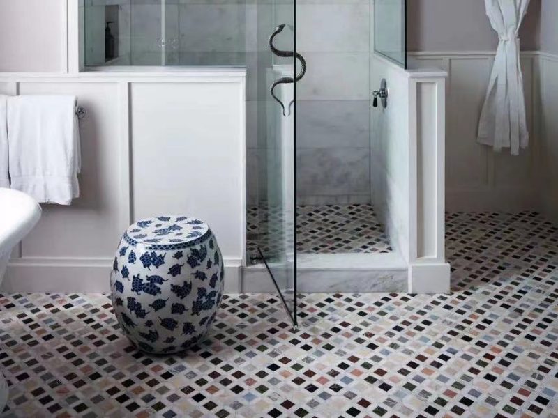 Decorative stone mosaic in bathroom floor tiles